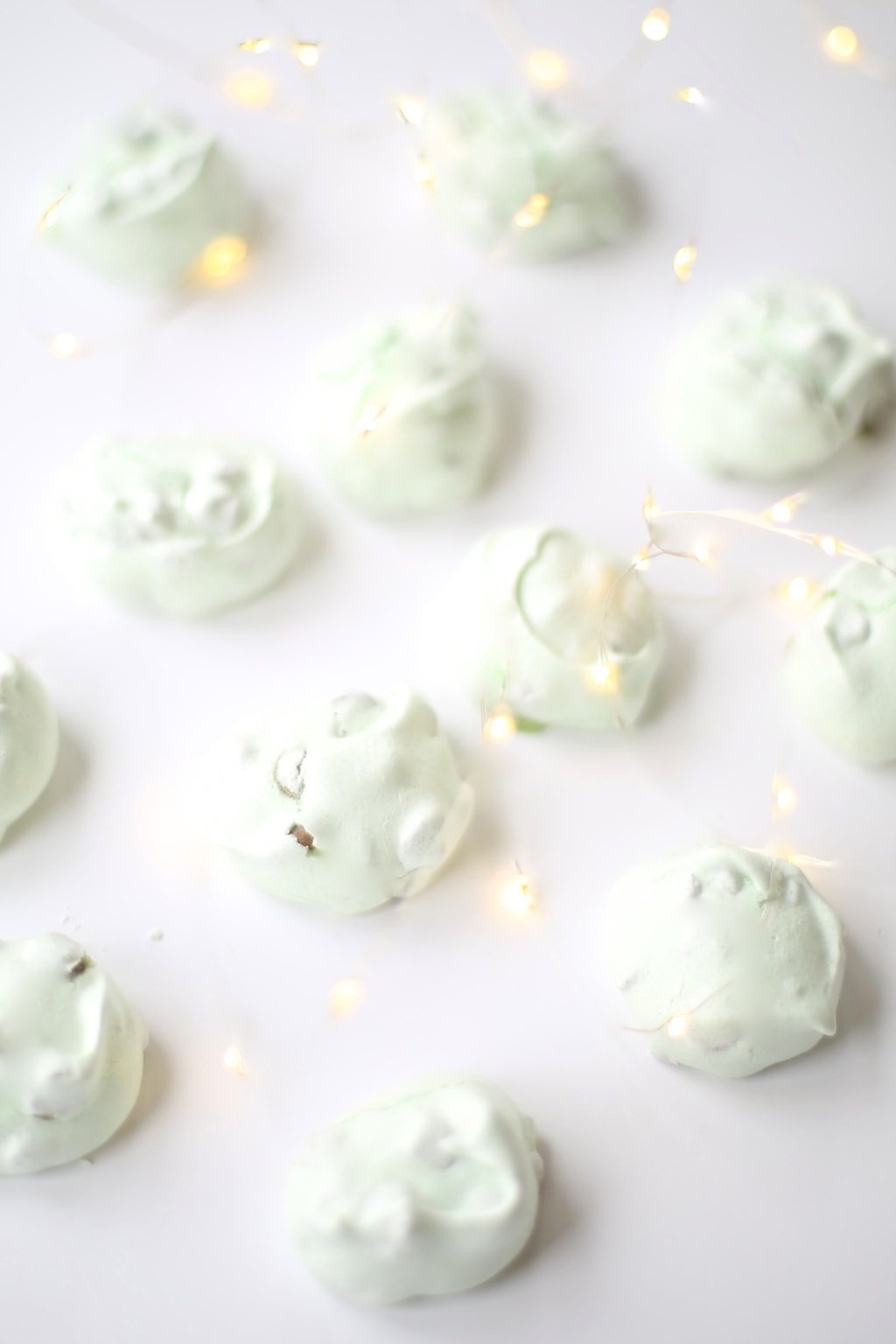 three ingredient meringue cookies with chocolate chips on white surface