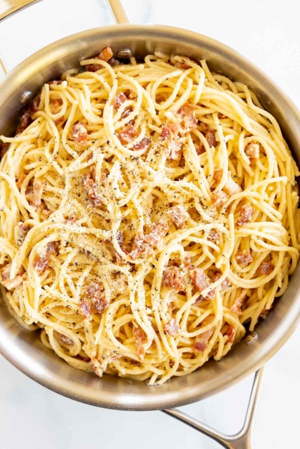 A large silver pot filled with spaghetti carbonara.