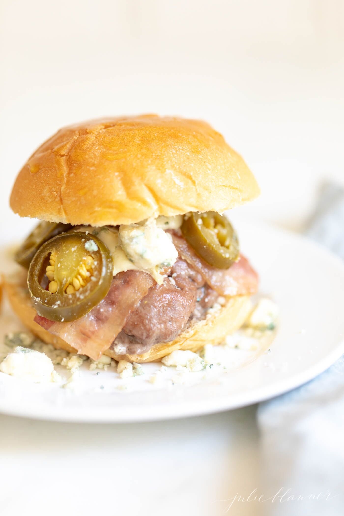 Mini slider close-up, with bacon, cheese and jalapenos. #sliders