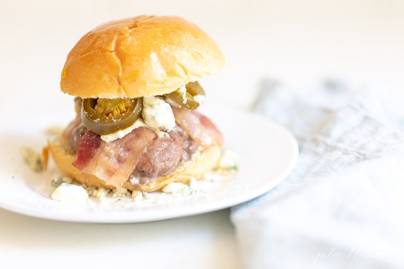 Mini slider close-up, with bacon, cheese and jalapenos. #sliders