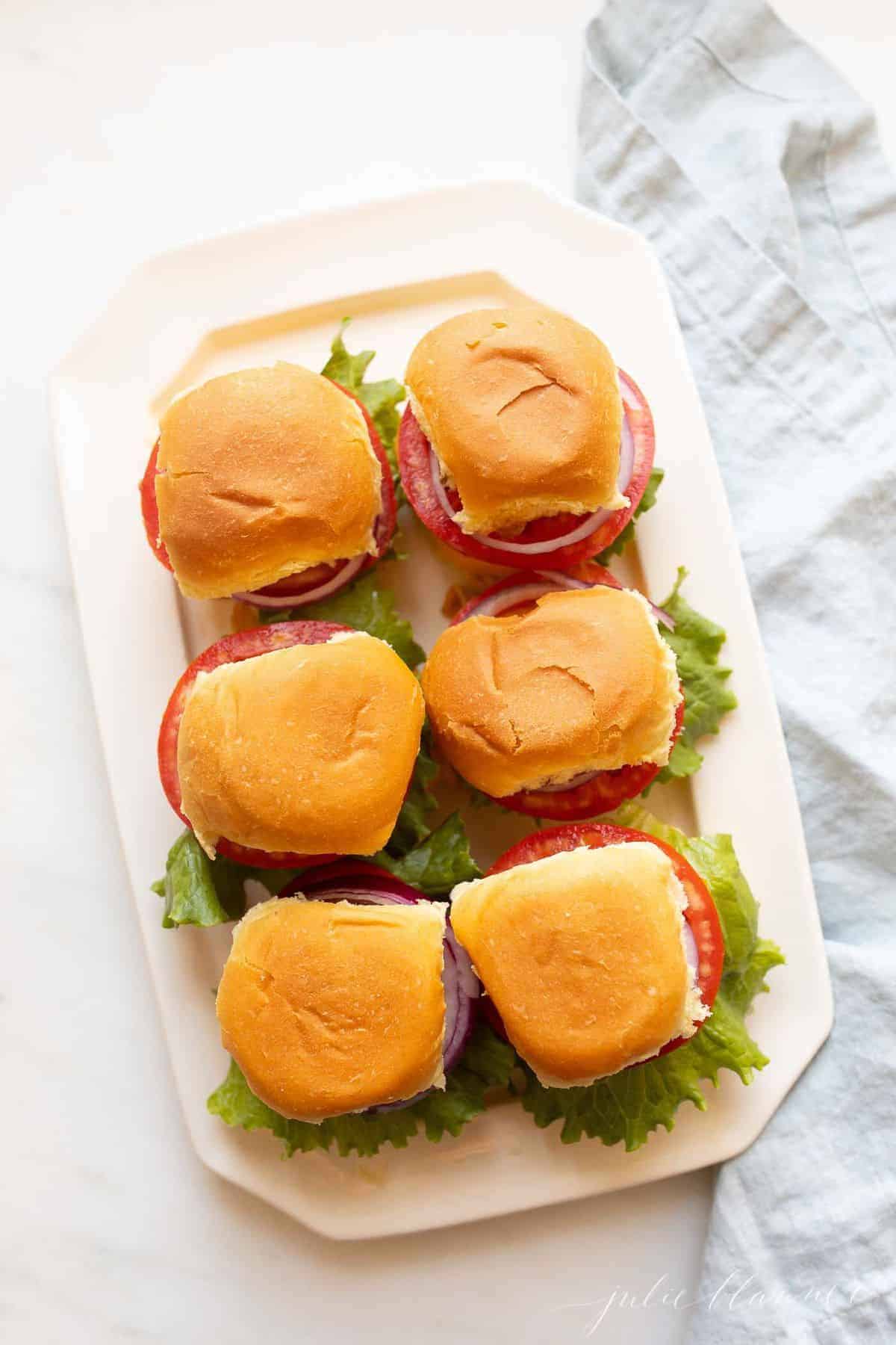 White platter featuring 6 sliders, down shot. #sliders