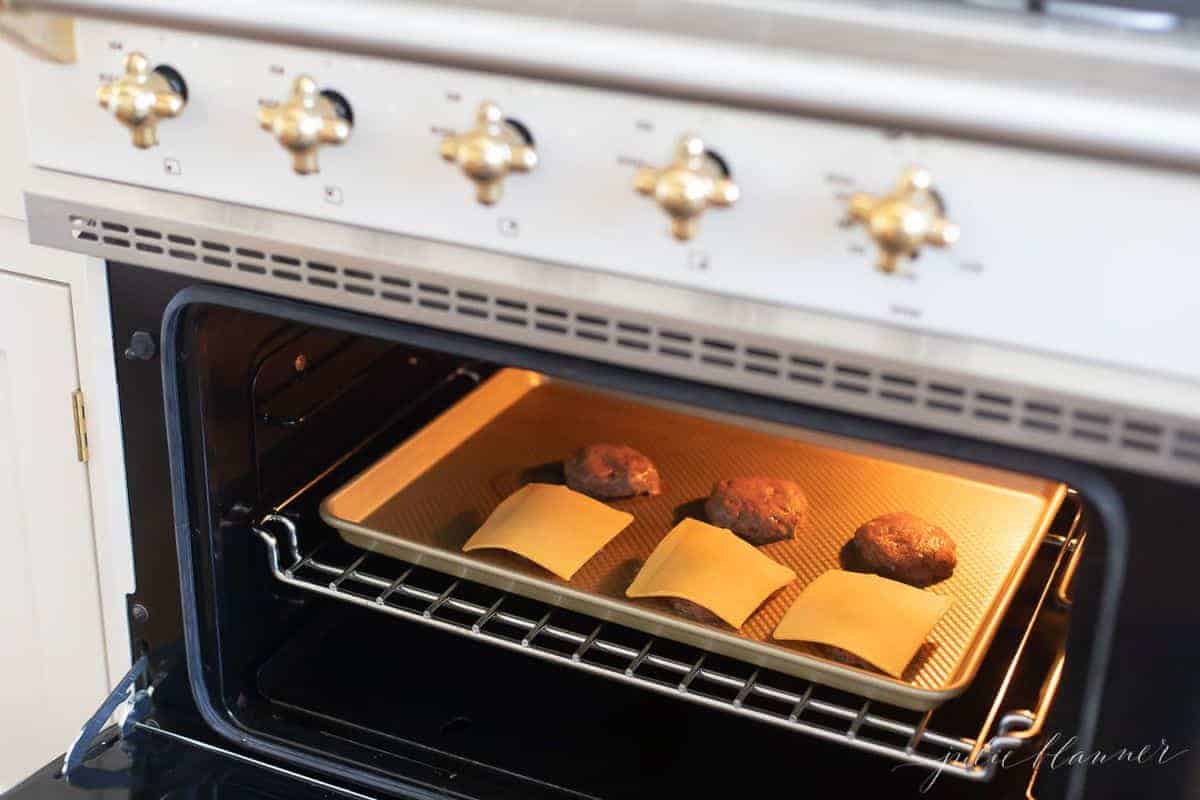 Sliders in the oven, half with cheese half without. 