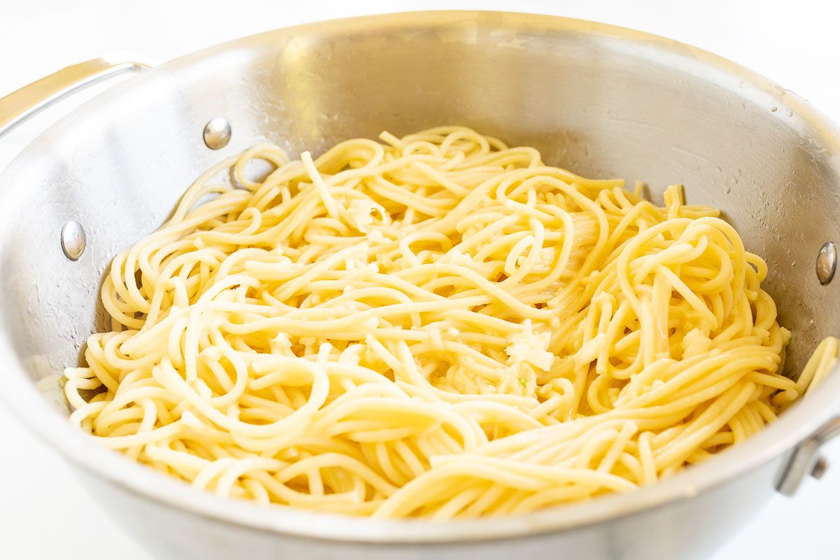 A silver pot full of cooked spaghetti