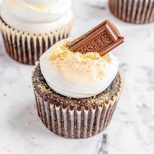 S'mores cupcakes on a marble surface.