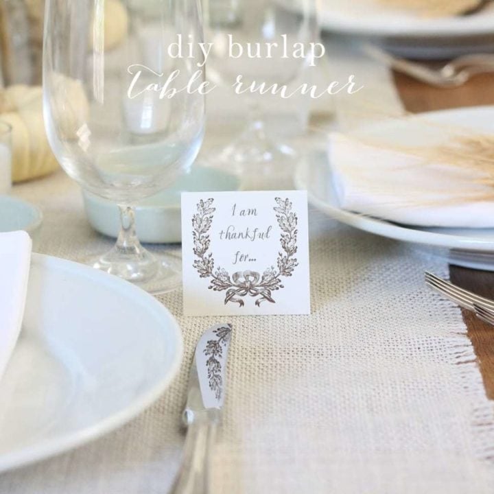 A set table with a burlap table runner.