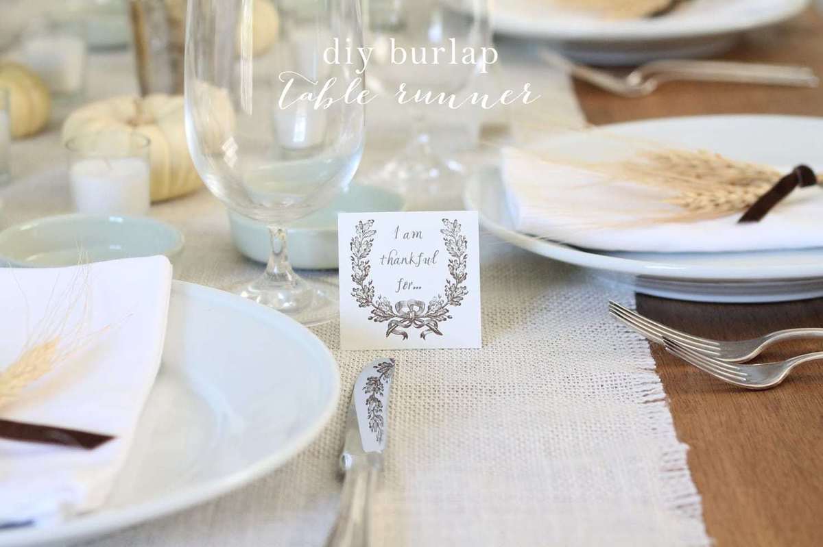A set table with a burlap table runner.