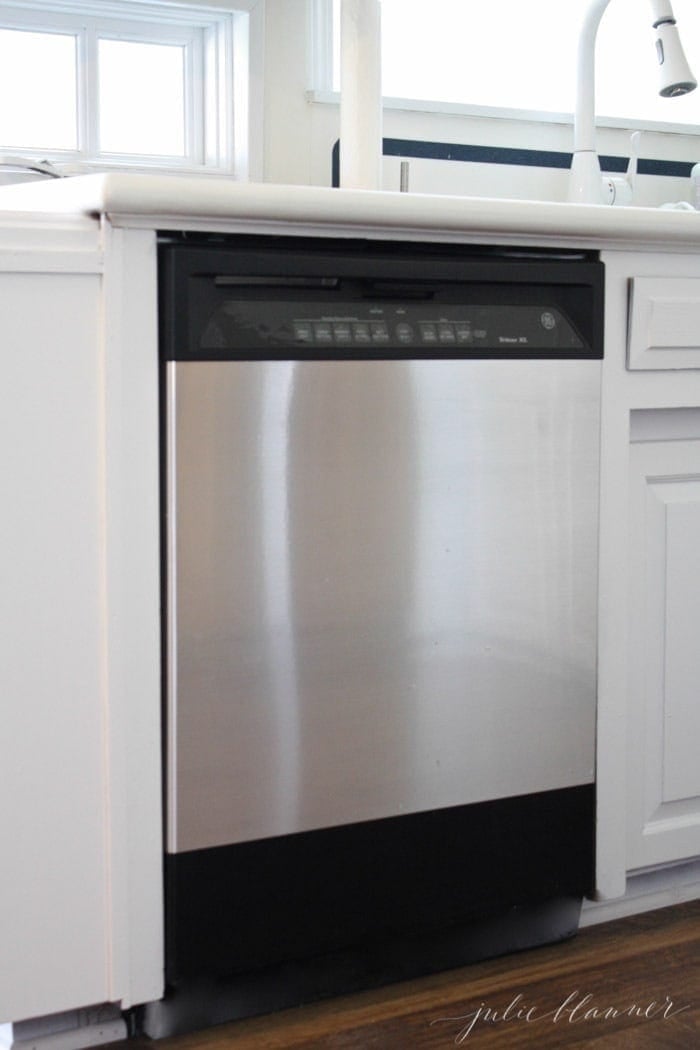 A kitchen with a DIY stainless steel dishwasher.