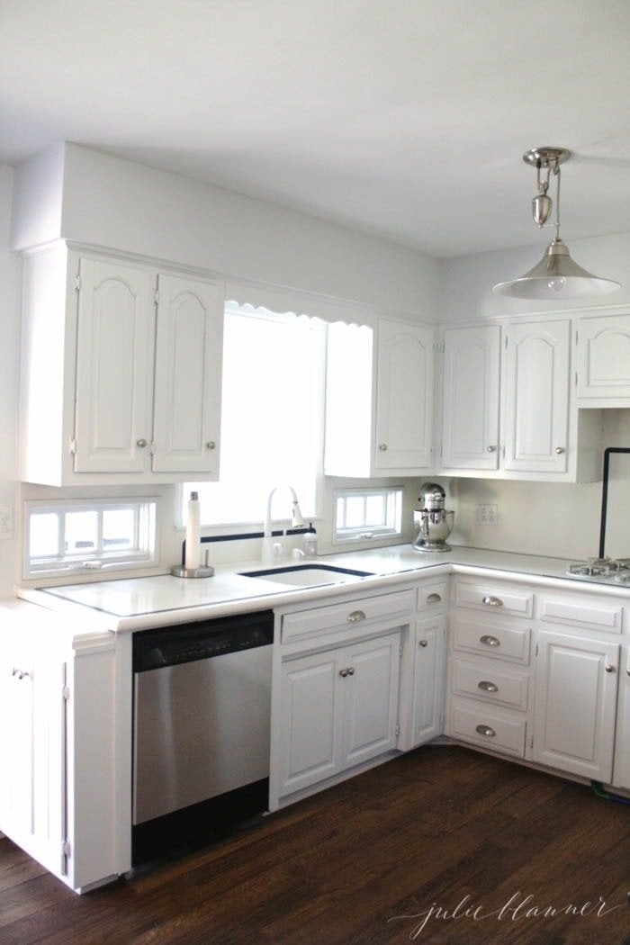 White kitchen with online stainless steel appliances