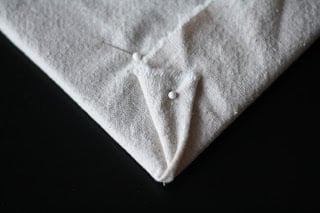 A pin holding together a piece of fabric.