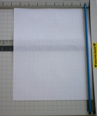 A cutting board with a piece of fabric to be used 