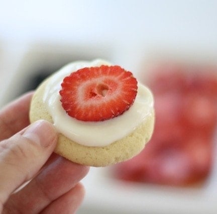 Fruit pizza icing topped with a strawberry