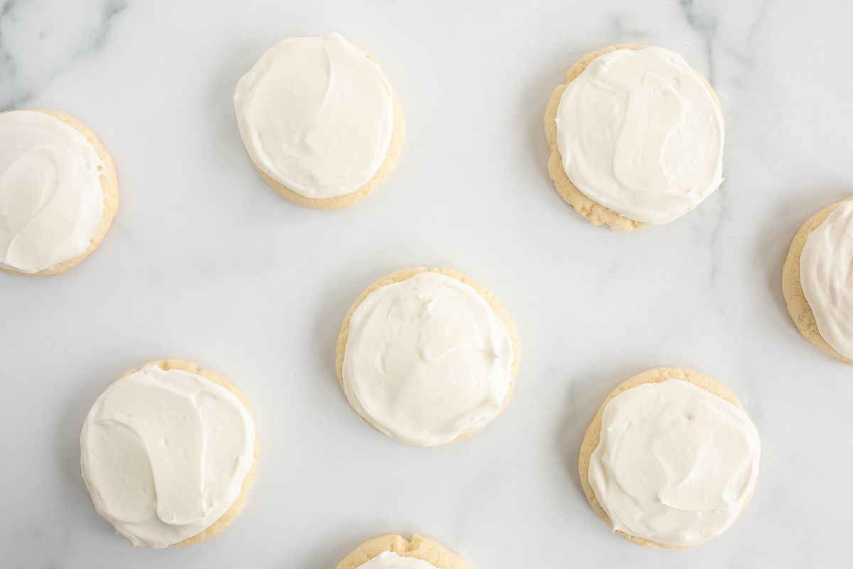 Sugar cookies with fruit pizza icing on a marble surface