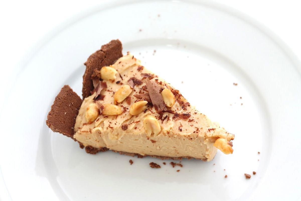 slice of peanut butter cheesecake recipe on white plate