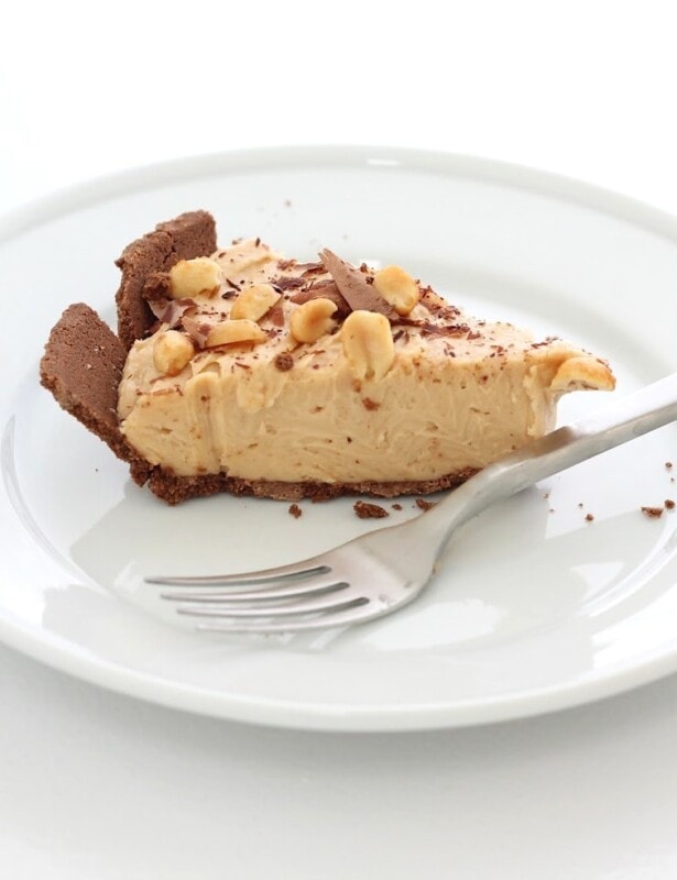 slice of peanut butter and chocolate cheesecake on white plate with fork