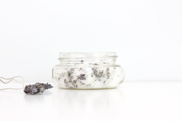 Pinecones next to a glass jar.