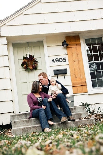 The Blanner family in front of their house, DIY shutters in sight. 