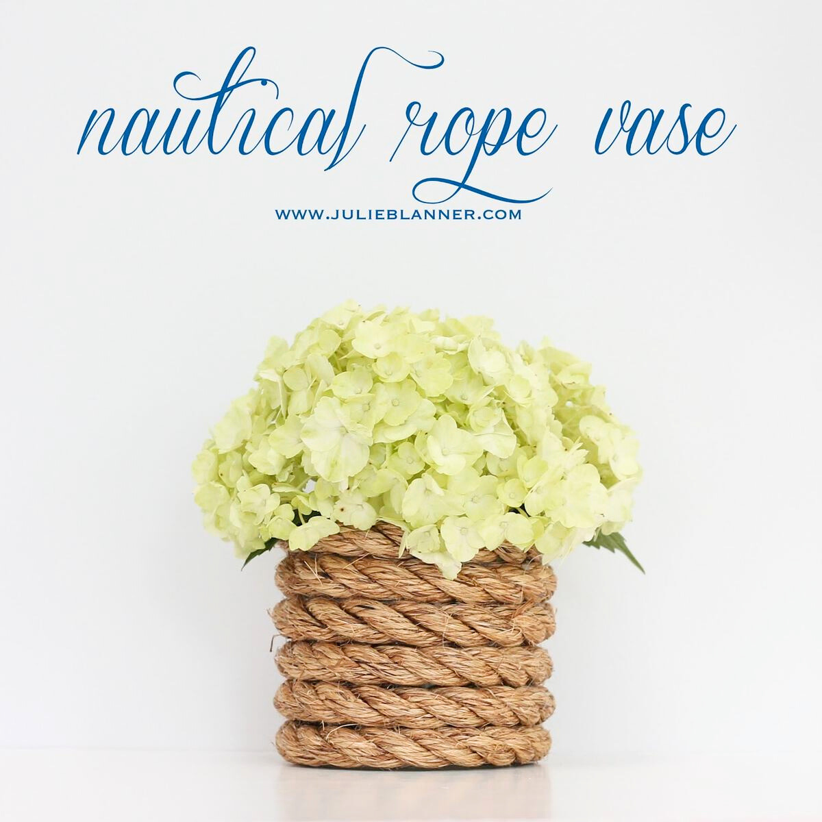 A nautical rope vase with white hydrangea inside. 