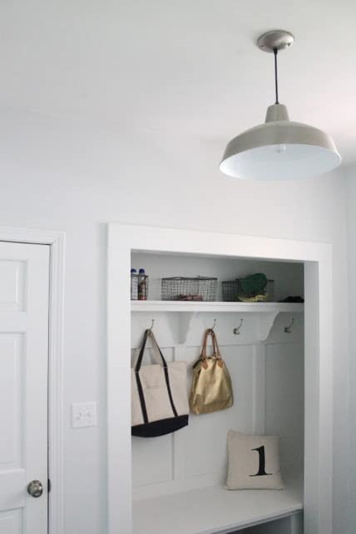 A closet converted to a mudroom bench and storage area