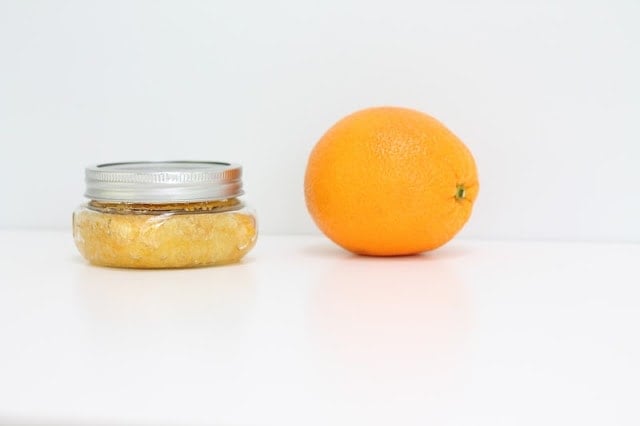 citrus sugar scrub next to an orange