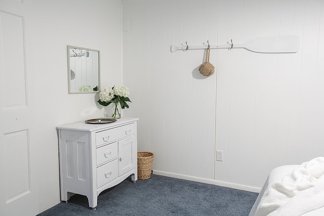 A bedroom with a small dresser