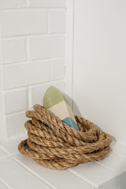 Rope and a striped bouy in a white basement guest room