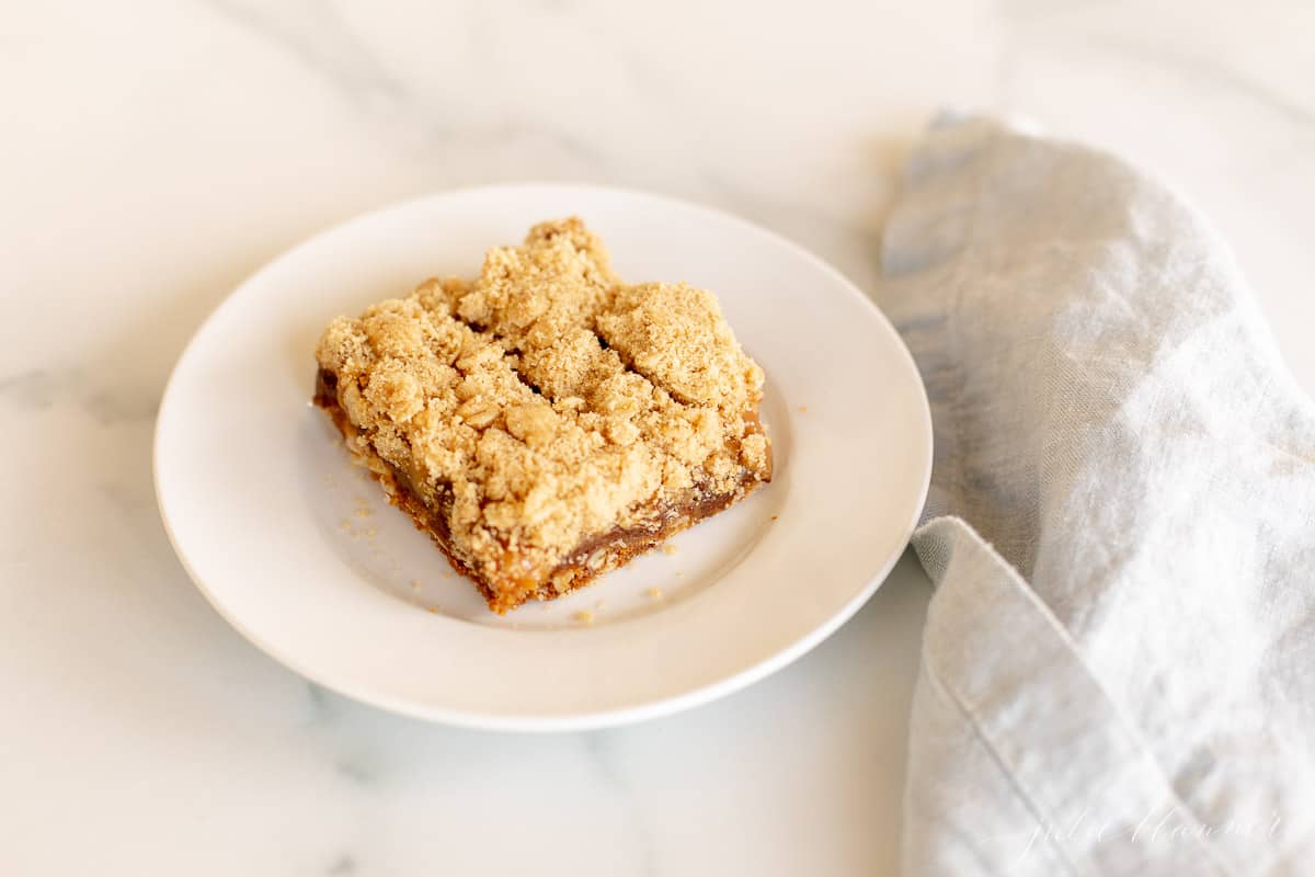 cookie bar with crumble on top next to blue napkin