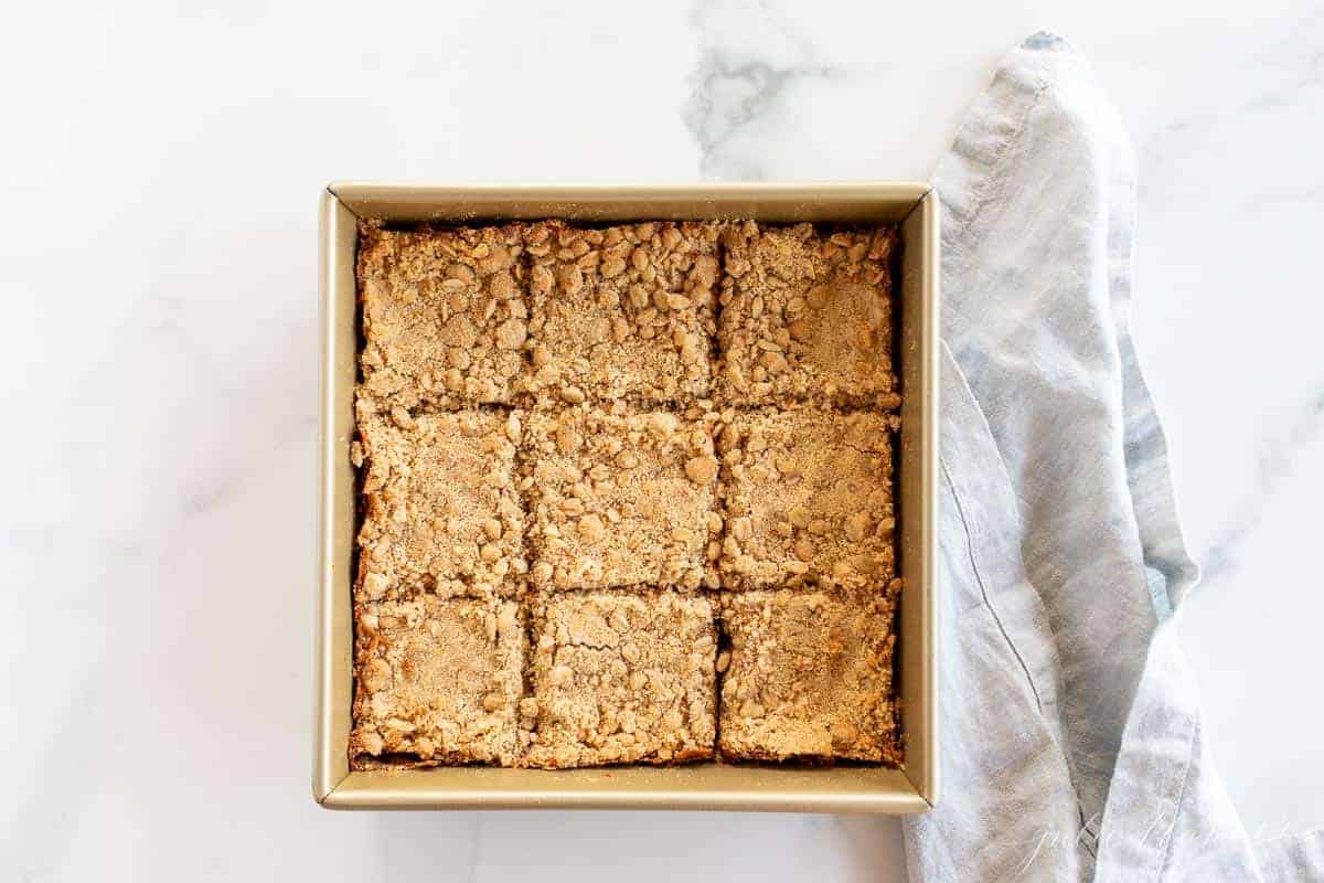 sliced bars in gold baking dish with blue napkin