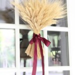 wheat sheaf fall wreath with ribbon hanging on door