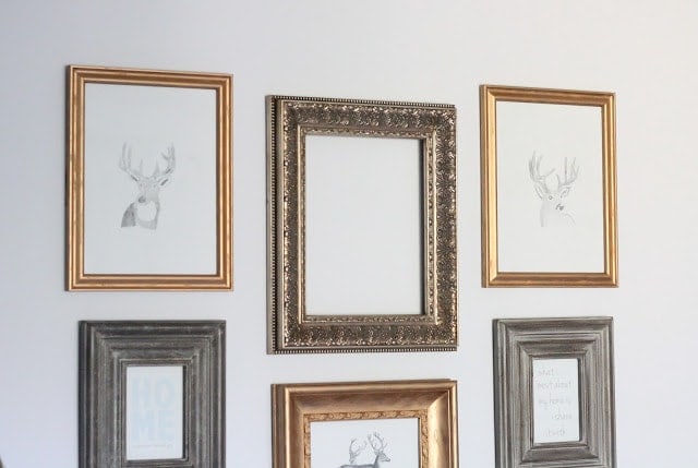Darker brass picture frames with a quote inside. Other lighter brass frames with deer inside. 