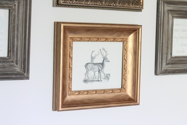 DIY gold gilded frames in a gallery wall over a sofa.