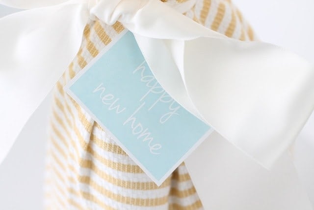 Happy new home tag on a gift.