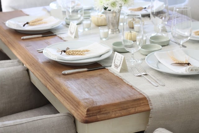 wood table set for fall with burlap table runner and wheat