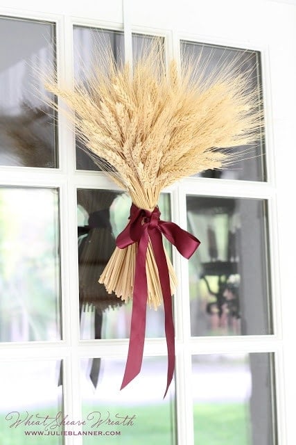 Wheat Sheaf Fall Wreath hanging on a white door.