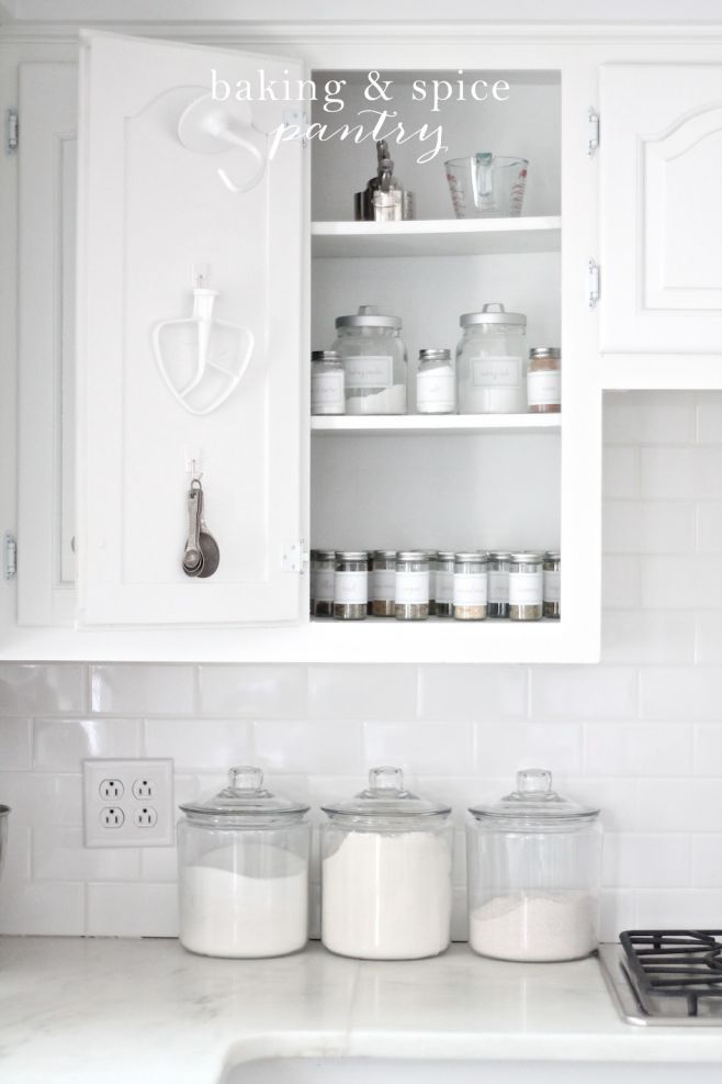 organized baking essentials in a white kitchen baking cabinet