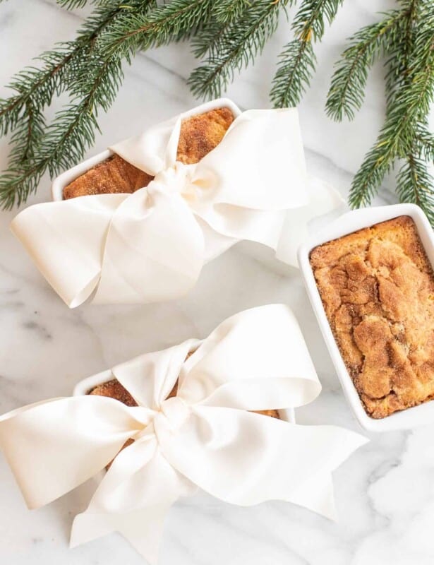 3 cinnamon bread loaves 2 gift wrapped in a bow by christmas greenery