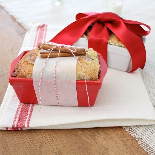 Two Christmas breads gift wrapped in dishes