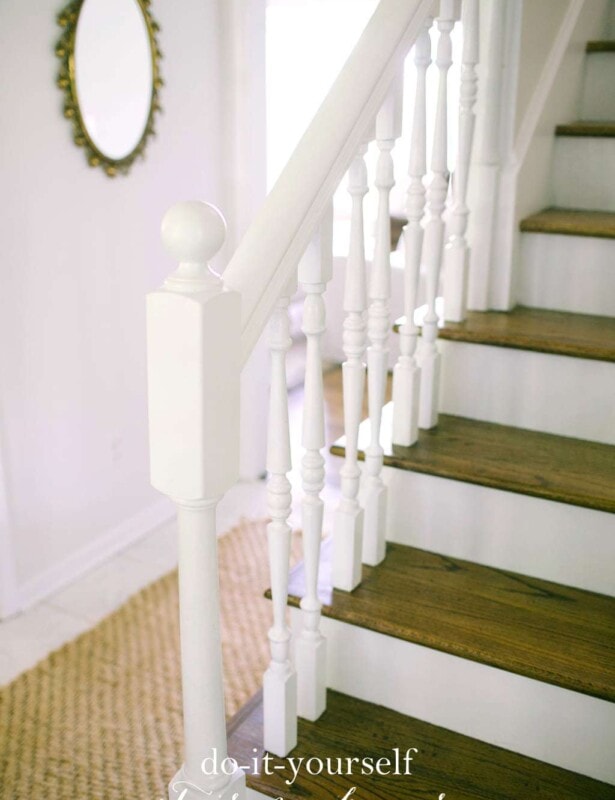 White stairs with wooden tops and white hand railings.