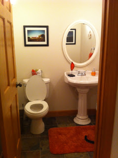 A bathroom with white appliances and festive poinsettias.