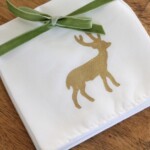 gold deer stenciled onto white hand towel