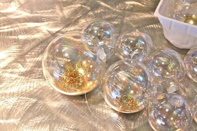 large craft ornament filled with gold glitter for the ornament garland