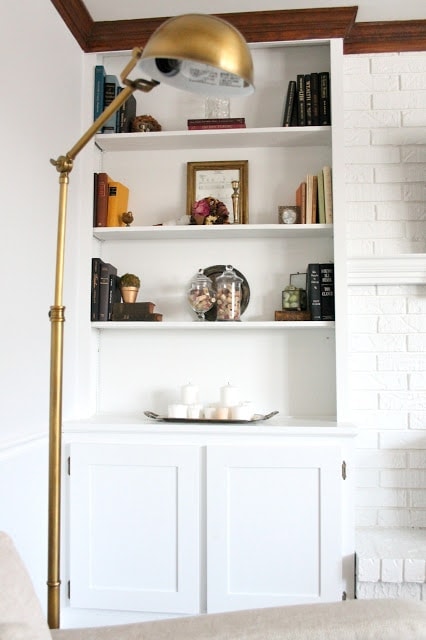 Shelves filled with books and other knick knacks. 