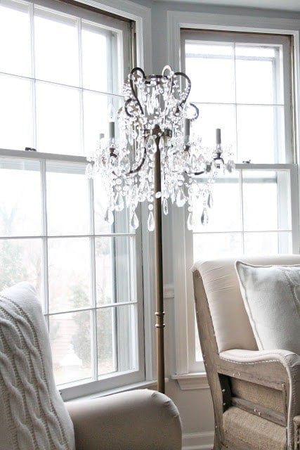 A chandelier next to a window