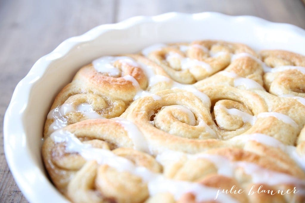 Baked heart shaped cinnamon rolls in a white baking dish