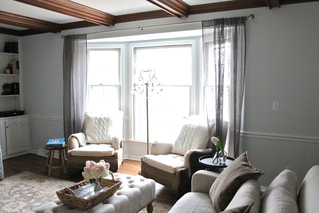 A living room filled with gray furniture and a large window