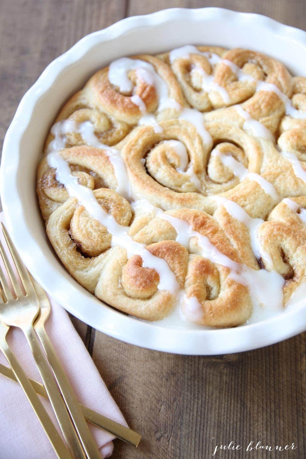 Heart shaped cinnamon rolls in a white baking dish
