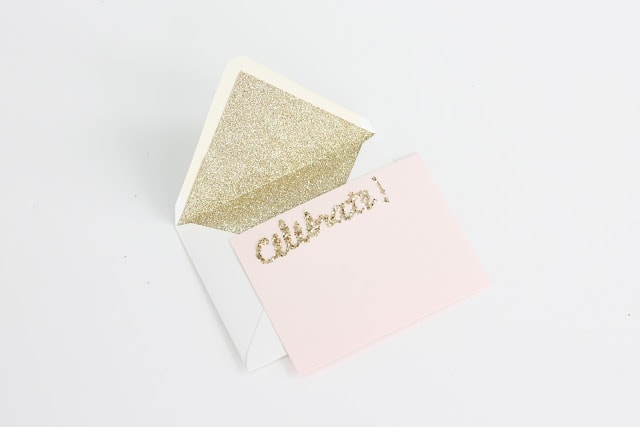 A gold glitter lined envelope