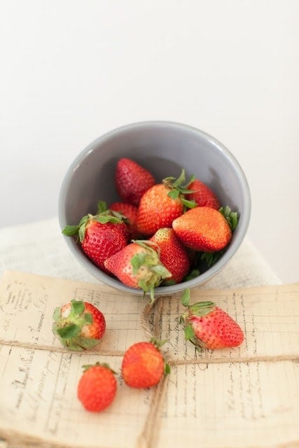 A gray bowl of strawberries.