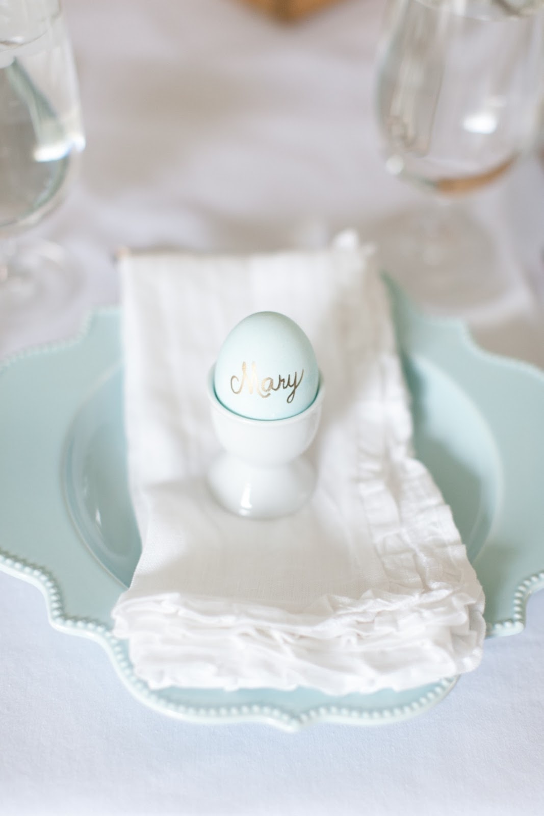 An easter placesetting with an egg in an egg cup, name written on it