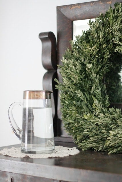 A wreath resting on a side table.