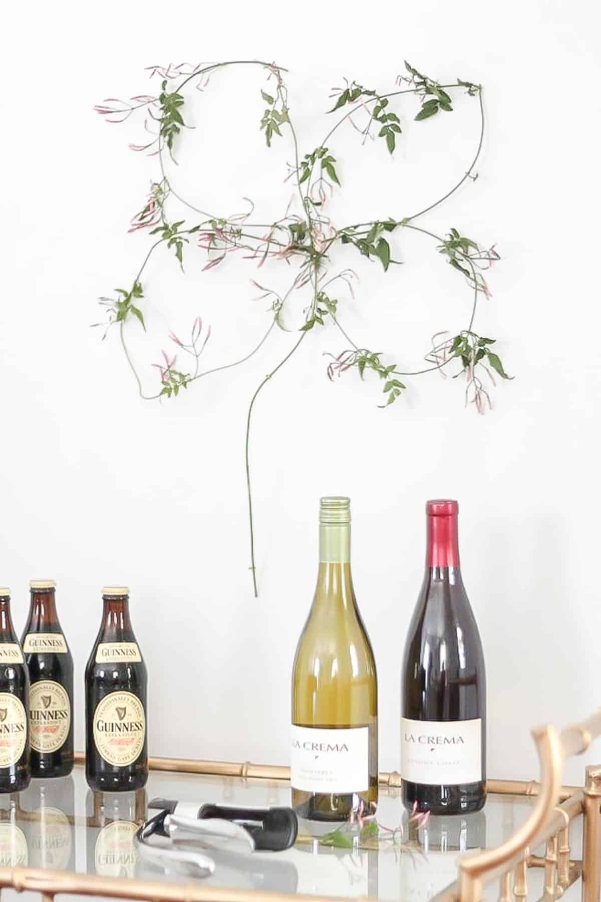 four leaf clover made from jasmine above bar cart with irish beer and wine